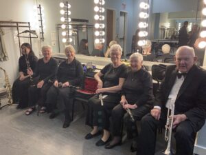 group of musicians seated together before a concert