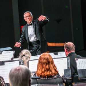 Conductor raises arm during concert