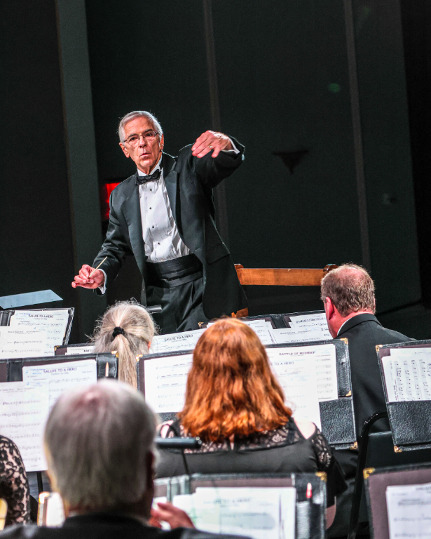 Conductor raises arm during concert